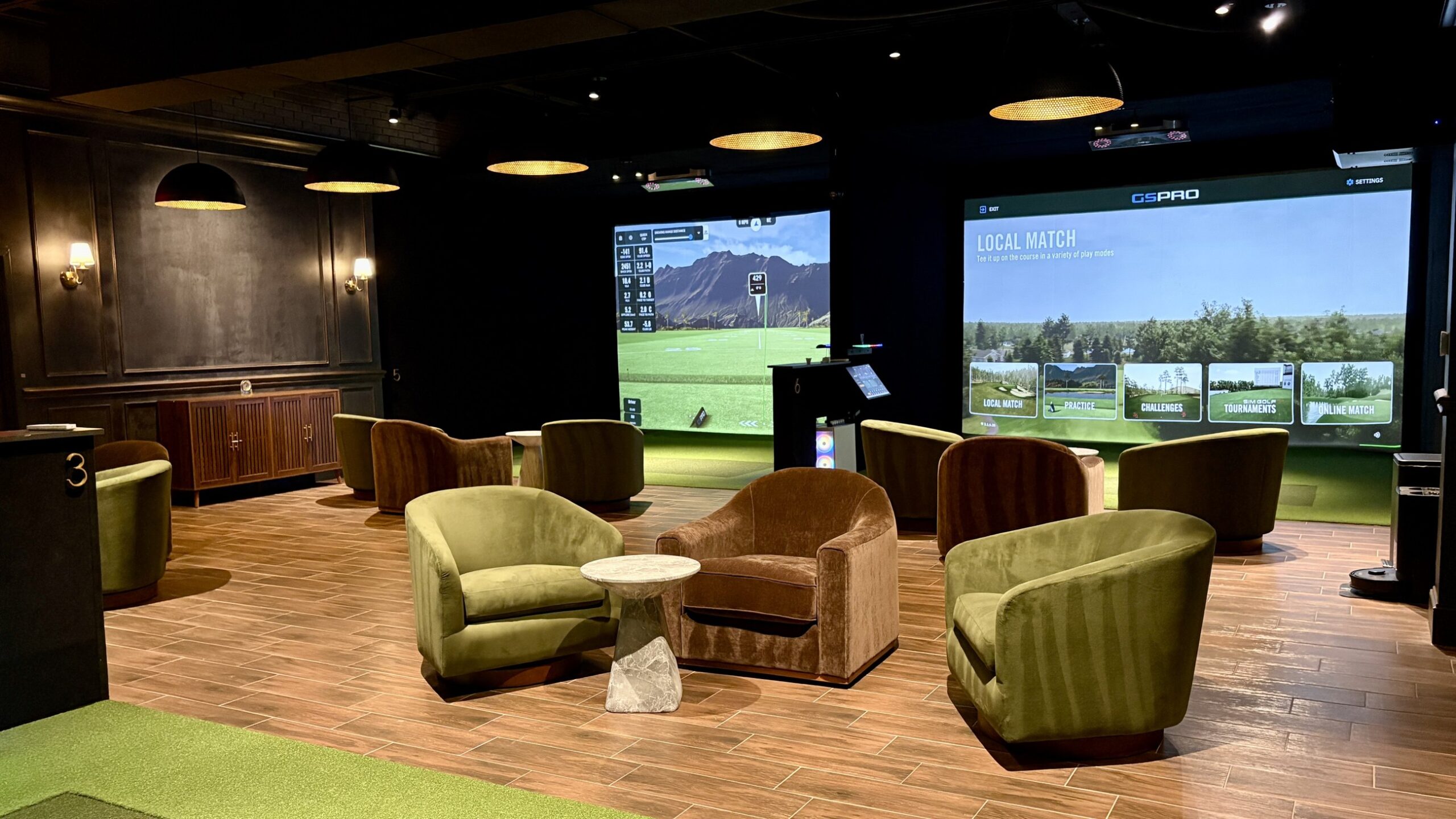 Back Tee Golf Club lounge seating with simulator bays